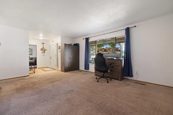a view of a room with gym equipment and a large window