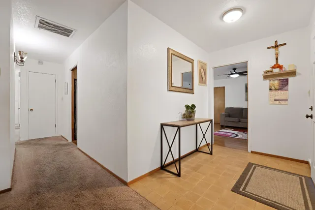 a view of hall way with furniture