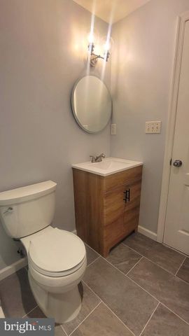 a view of a livingroom with wooden floor a fireplace and window