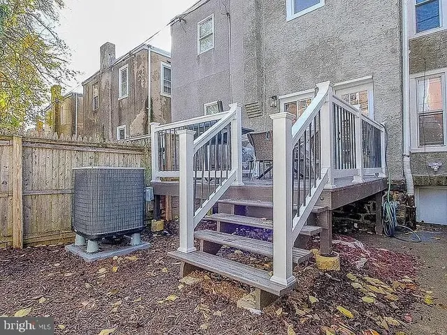 a view of a roof deck with table and chairs and wooden floor