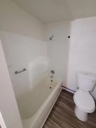 a bathroom with a bathtub and toilet