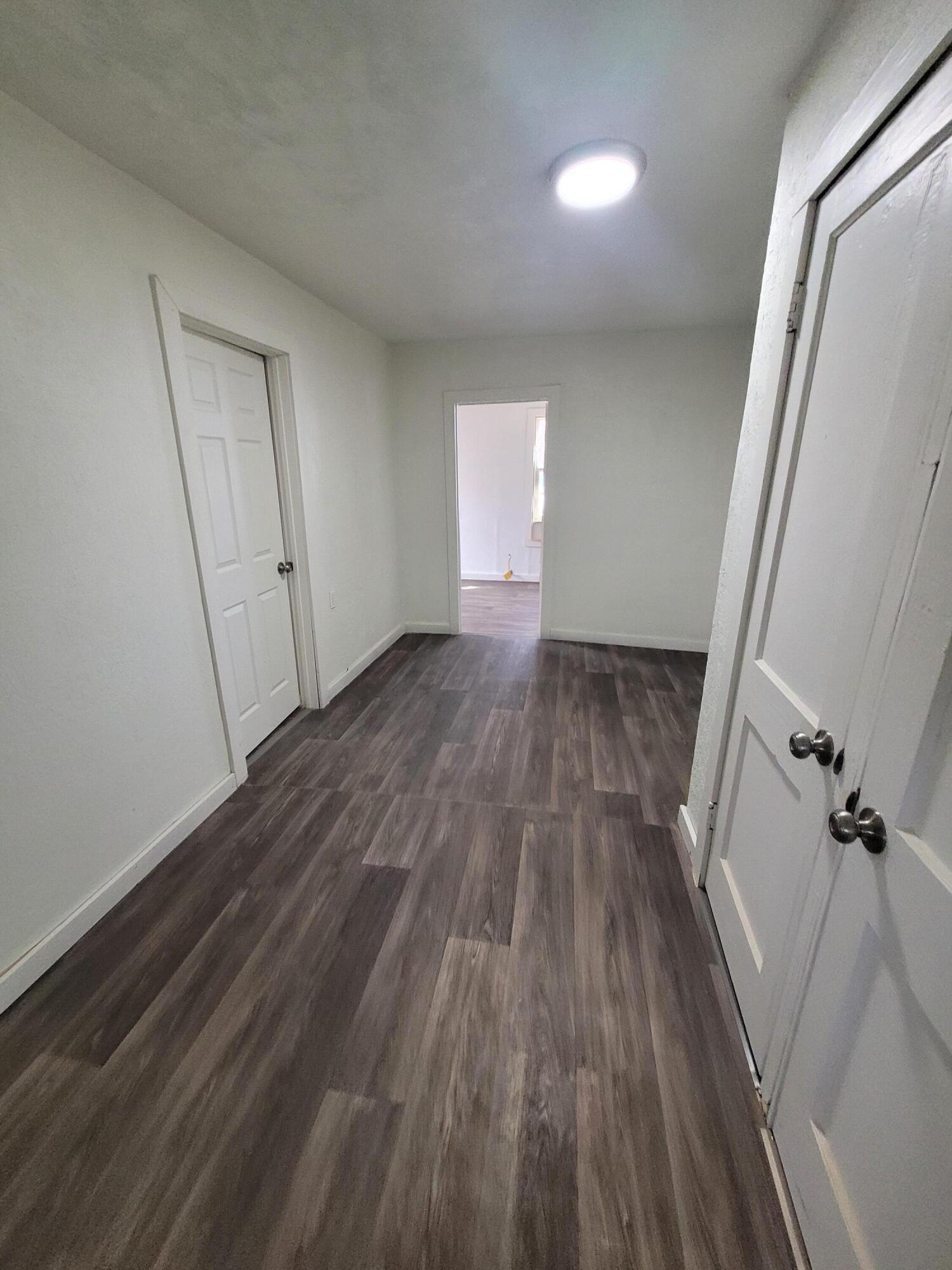 1055 South 3rd Street Slaton, TX 79364 - Photo 9 of 13 a view of a room with wooden floor and window