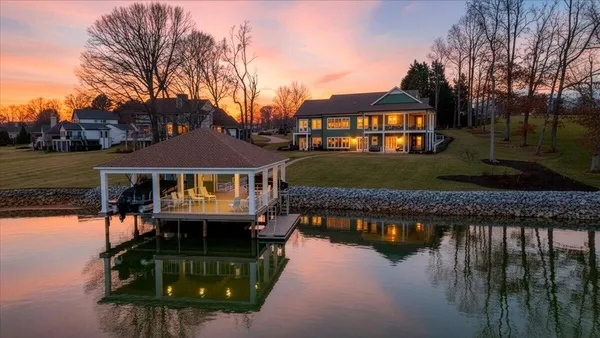 a front view of a house with a garden and yard