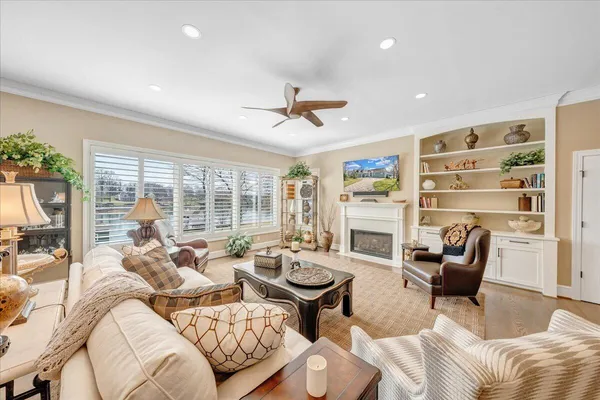 a large kitchen with kitchen island a stove a sink a center island and a wooden floor