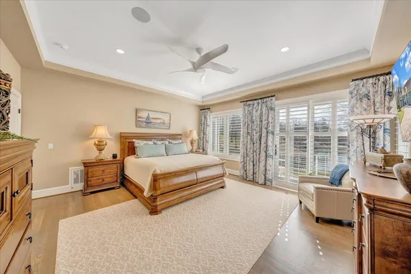 a dining room with furniture a chandelier and wooden floor