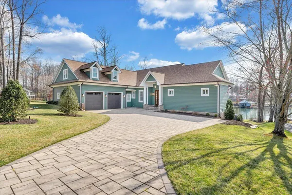 a living room with furniture floor to ceiling window and a flat screen tv