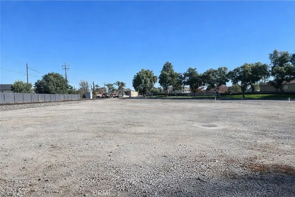 a view of a field with trees in the background
