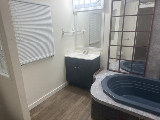 1100 Pine Top Road Toone, TN 38381 - Photo 22 of 40 Bathroom featuring a dark vanity with a white countertop and a framed mirror