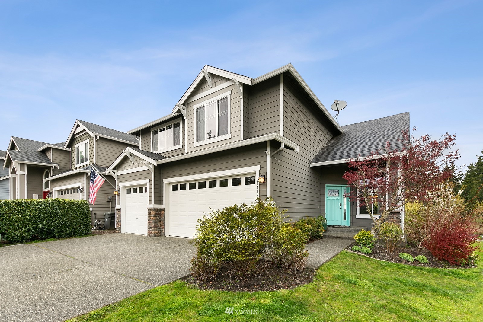 21117 Meridian Place West Bothell, WA 98021 - Photo 2 of 30 a front view of a house with a yard and garage
