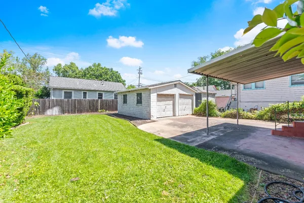 a view of a house with a yard and sitting area