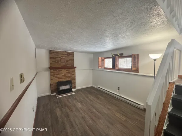 wooden floor in an empty room with a fireplace