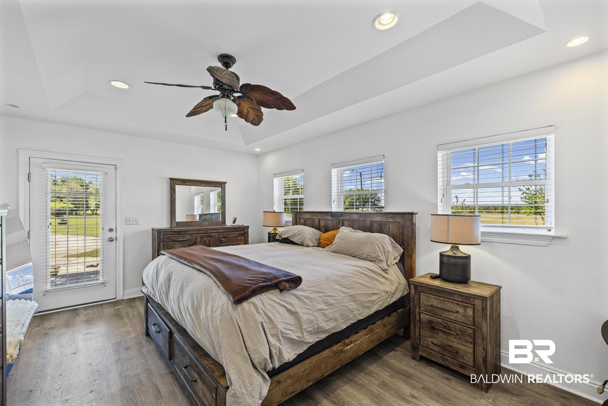 32875 Faircloth Road Lillian, AL 36549 - Photo 35 of 85 Bedroom featuring a raised ceiling, recessed lighting, access to exterior, dark wood-style floors, and ceiling fan