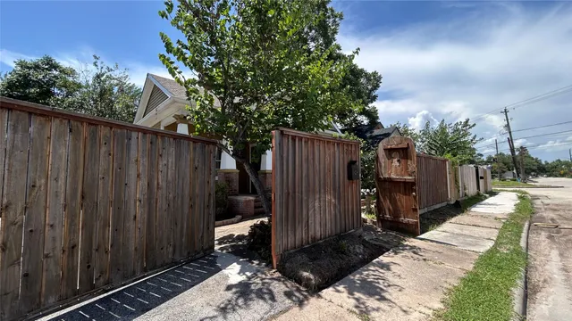 a view of a backyard with wooden fence