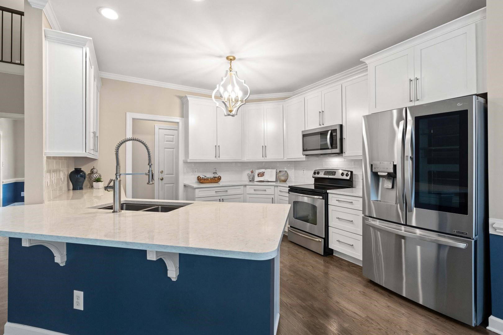 8215 Gadsen Court Raleigh, NC 27613 - Photo 12 of 48 a kitchen with kitchen island granite countertop stainless steel appliances cabinets a sink and a counter top space