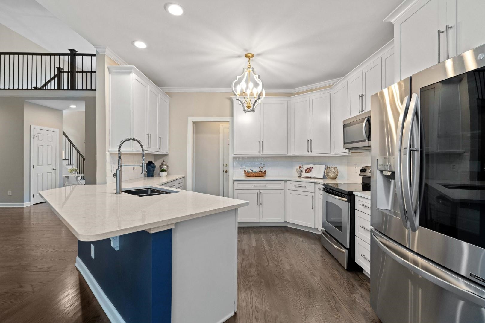 8215 Gadsen Court Raleigh, NC 27613 - Photo 13 of 48 a kitchen with a sink stainless steel appliances and white cabinets
