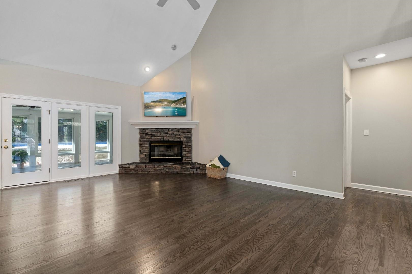 8215 Gadsen Court Raleigh, NC 27613 - Photo 17 of 48 an empty room with wooden floor fire place and windows
