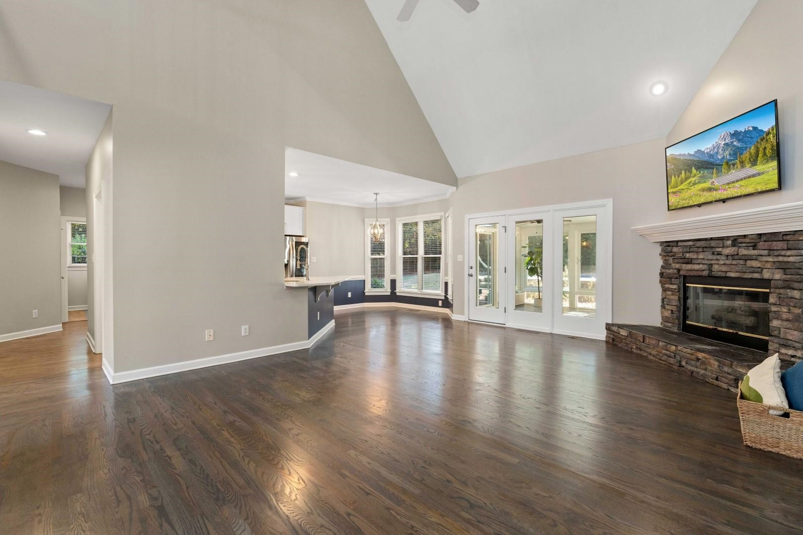 8215 Gadsen Court Raleigh, NC 27613 - Photo 18 of 48 a view of an empty room with wooden floor and a fireplace