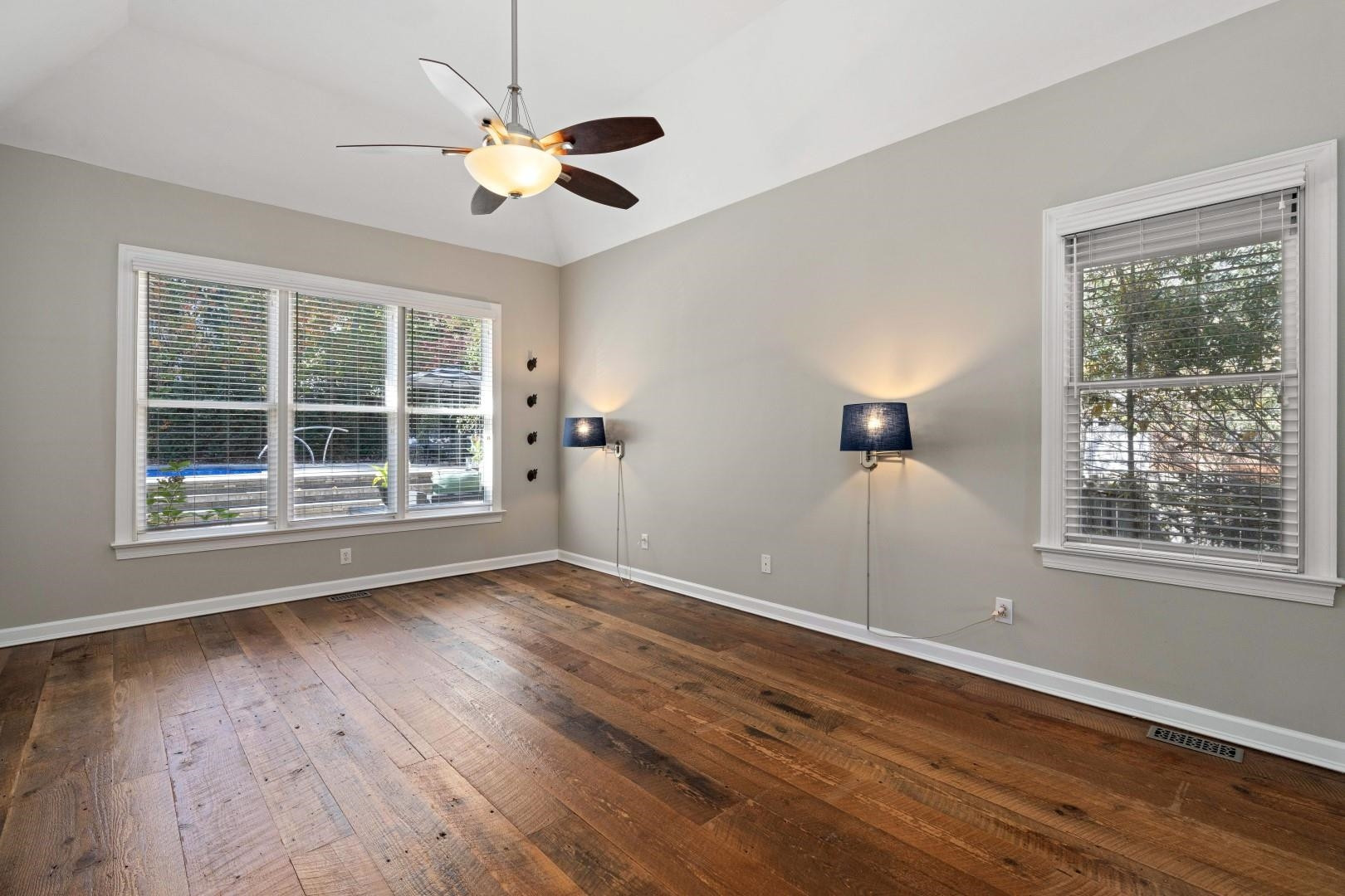 8215 Gadsen Court Raleigh, NC 27613 - Photo 22 of 48 a view of an empty room with wooden floor and a window