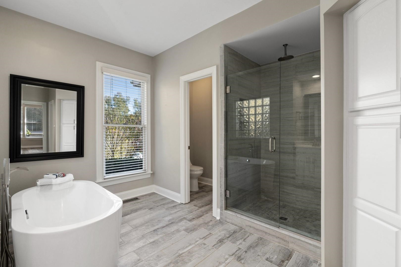 8215 Gadsen Court Raleigh, NC 27613 - Photo 24 of 48 a bathroom with a bathtub and shower