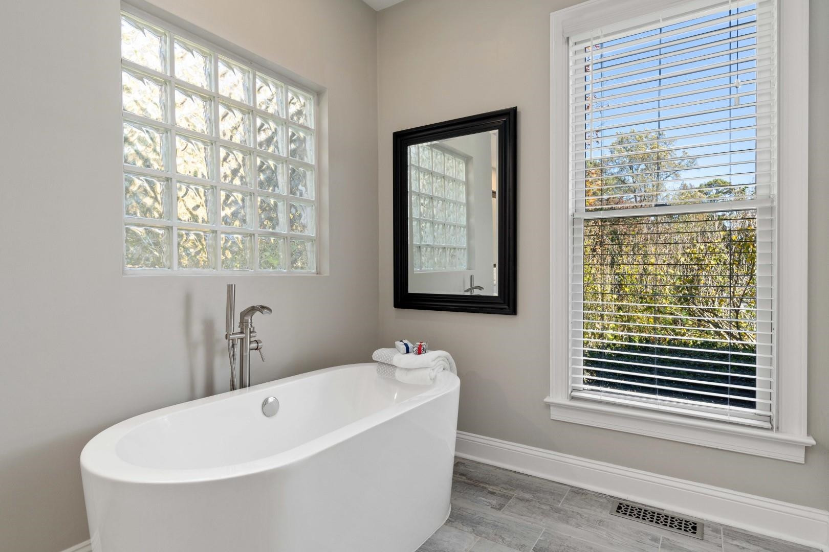 8215 Gadsen Court Raleigh, NC 27613 - Photo 25 of 48 a white bath tub sitting next to a window