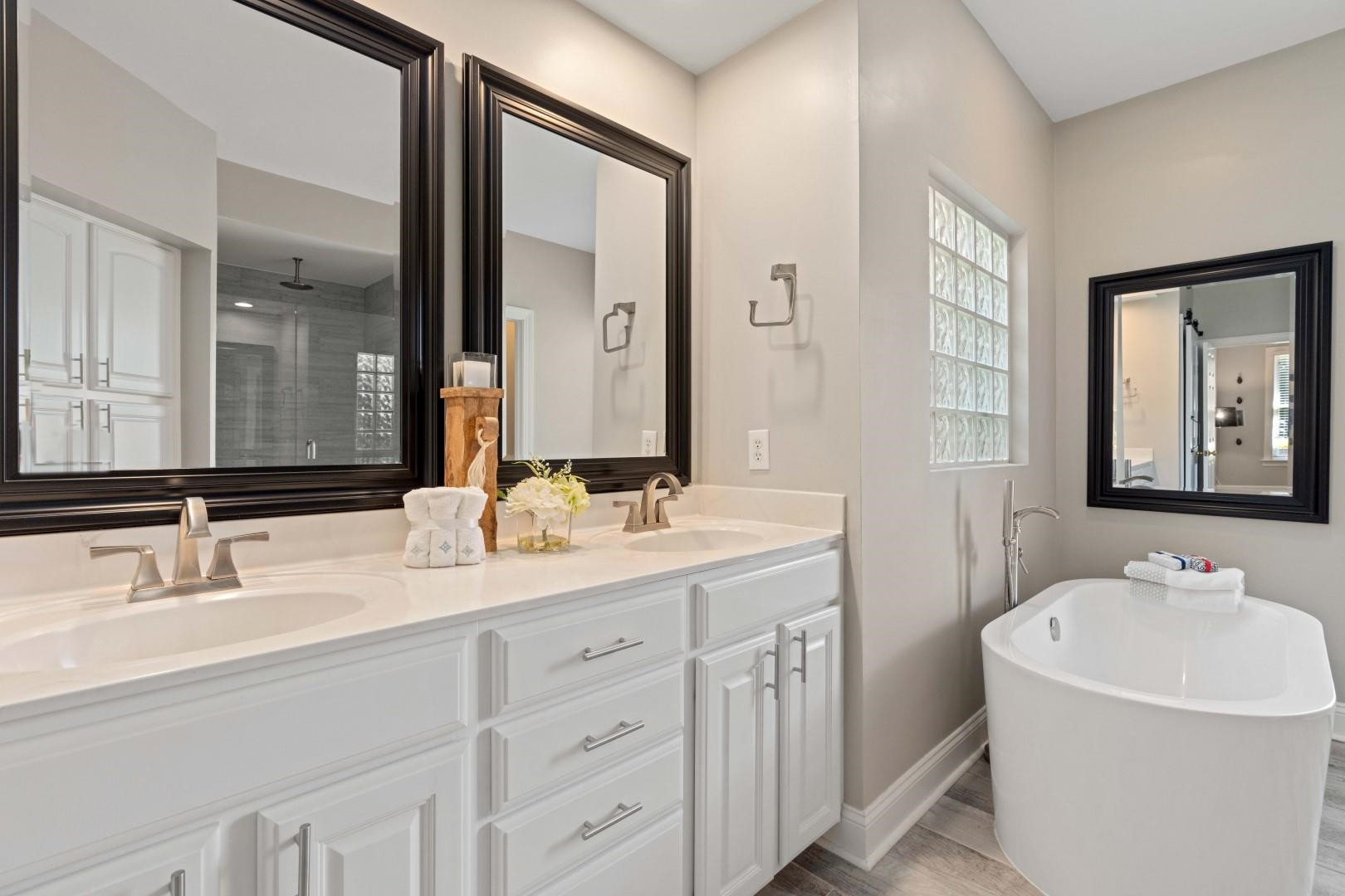 8215 Gadsen Court Raleigh, NC 27613 - Photo 26 of 48 a bathroom with double sink and a mirror