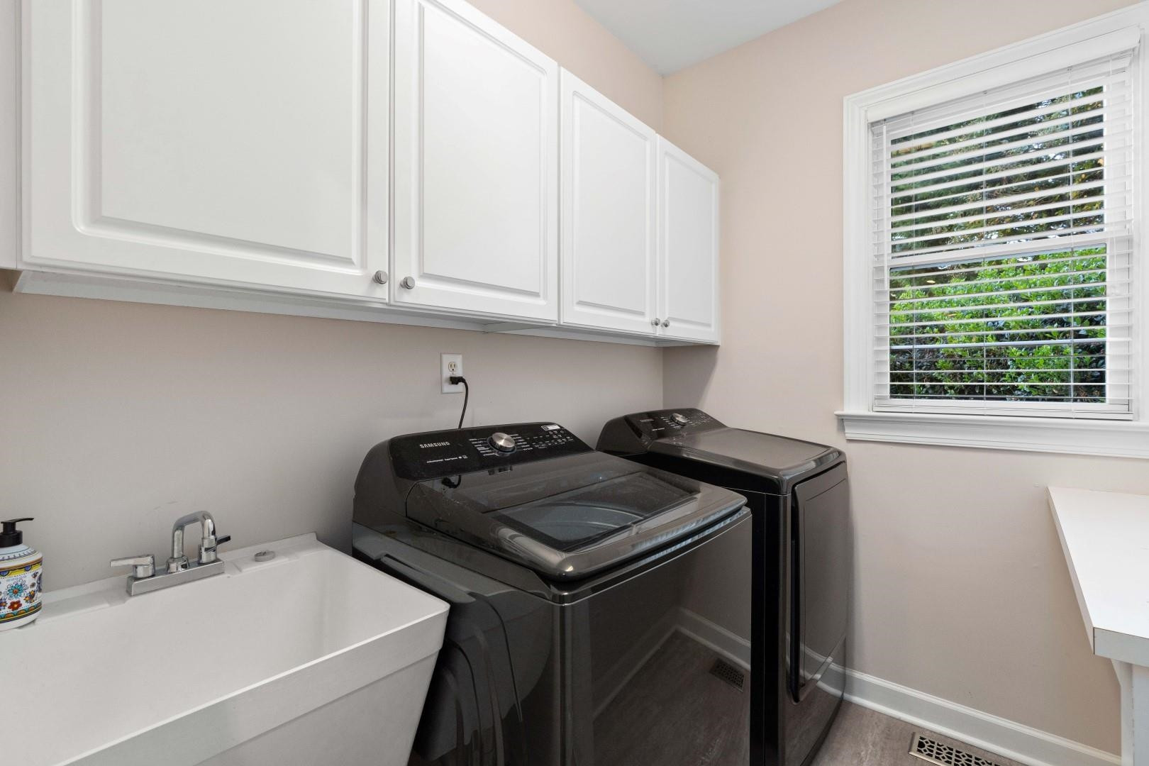 8215 Gadsen Court Raleigh, NC 27613 - Photo 31 of 48 a utility room with sink dryer and washer