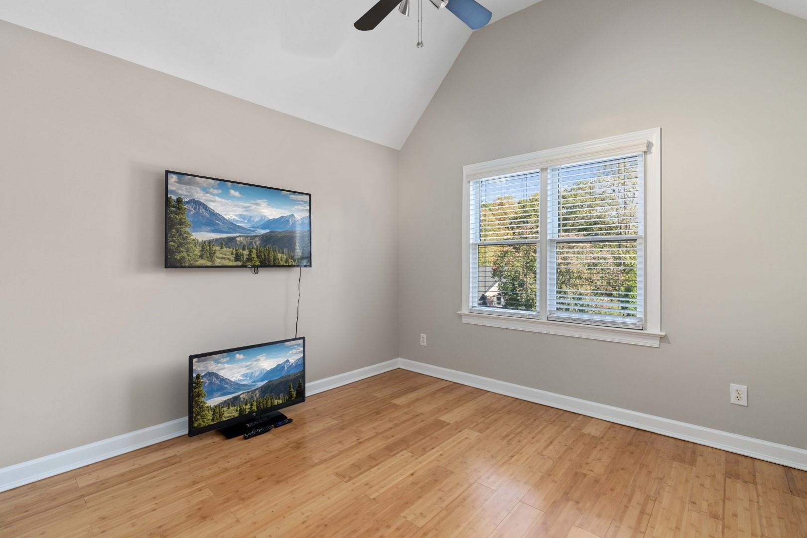 8215 Gadsen Court Raleigh, NC 27613 - Photo 32 of 48 a view of an empty room with a window and wooden floor