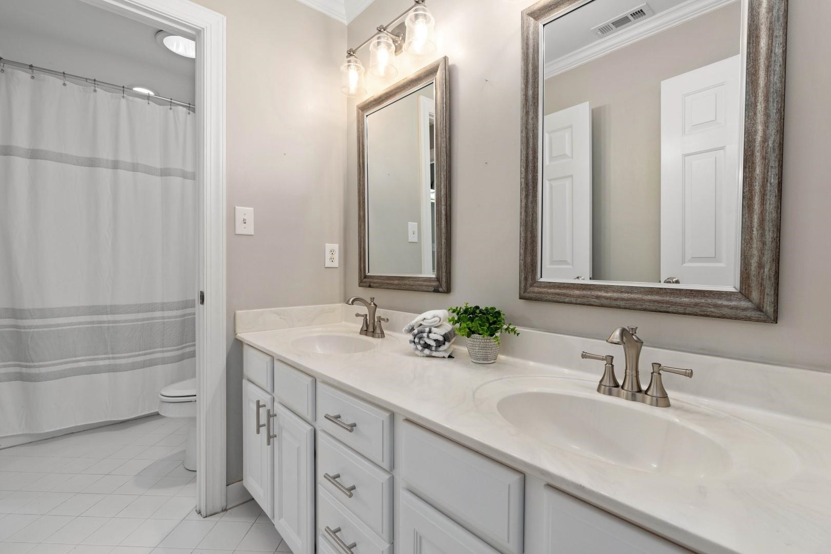 8215 Gadsen Court Raleigh, NC 27613 - Photo 34 of 48 a bathroom with a sink and a mirror