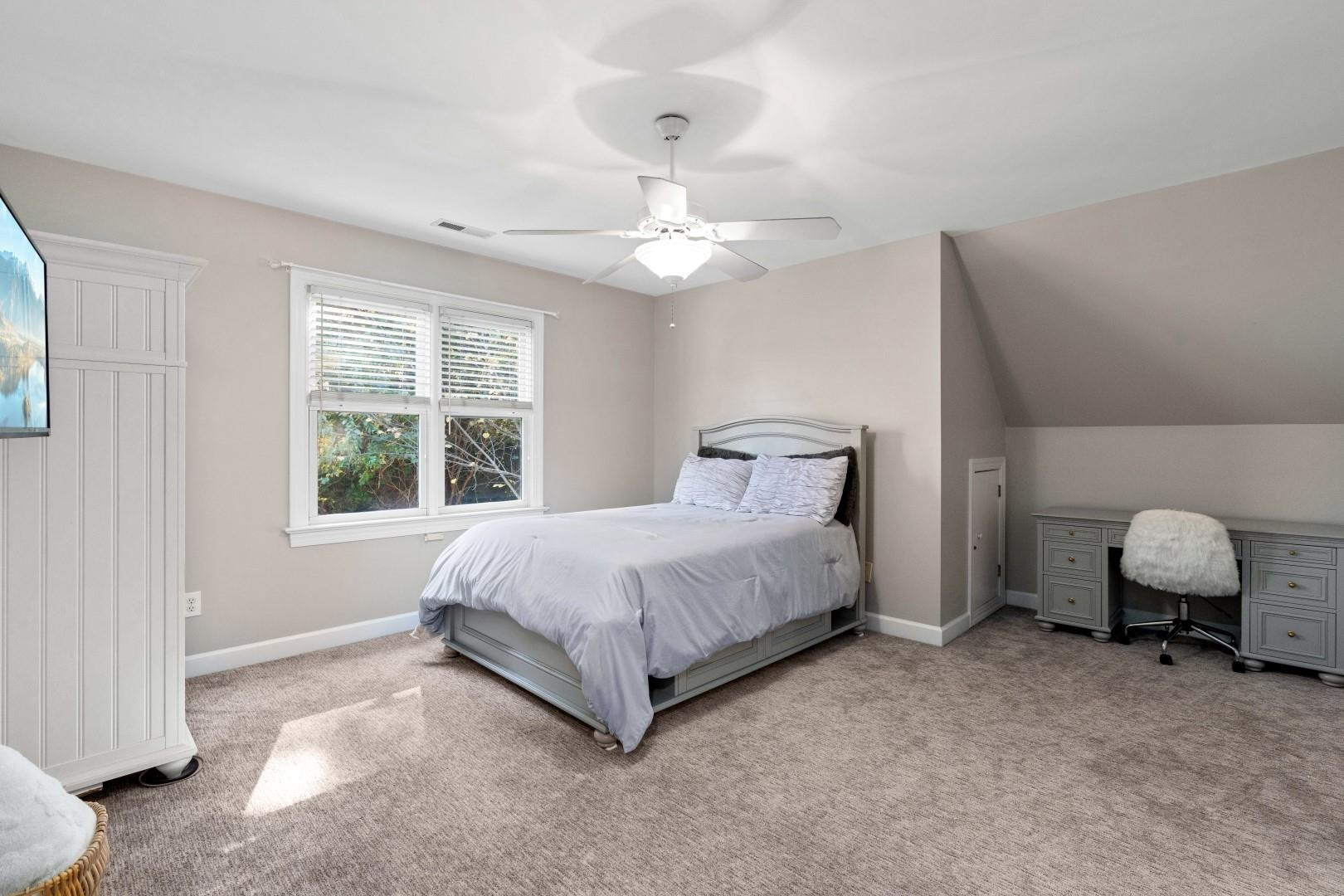 8215 Gadsen Court Raleigh, NC 27613 - Photo 37 of 48 a spacious bedroom with a bed and a window