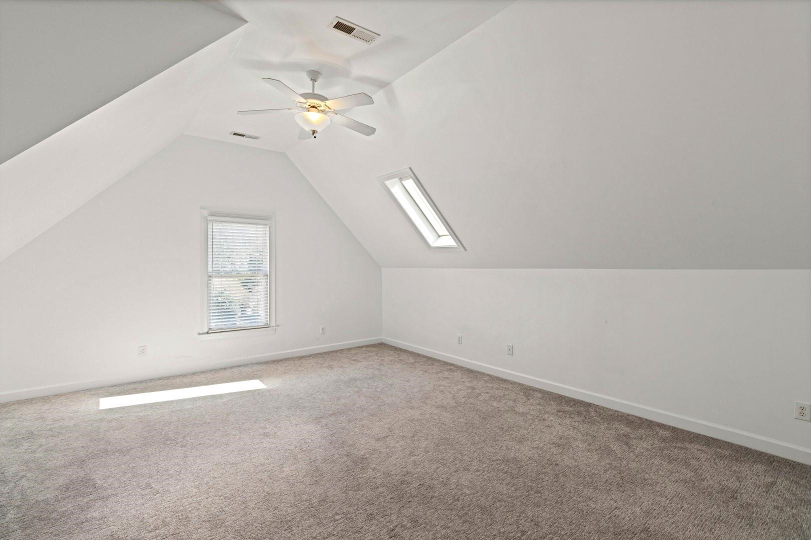 8215 Gadsen Court Raleigh, NC 27613 - Photo 38 of 48 en empty room with windows and ceiling fan