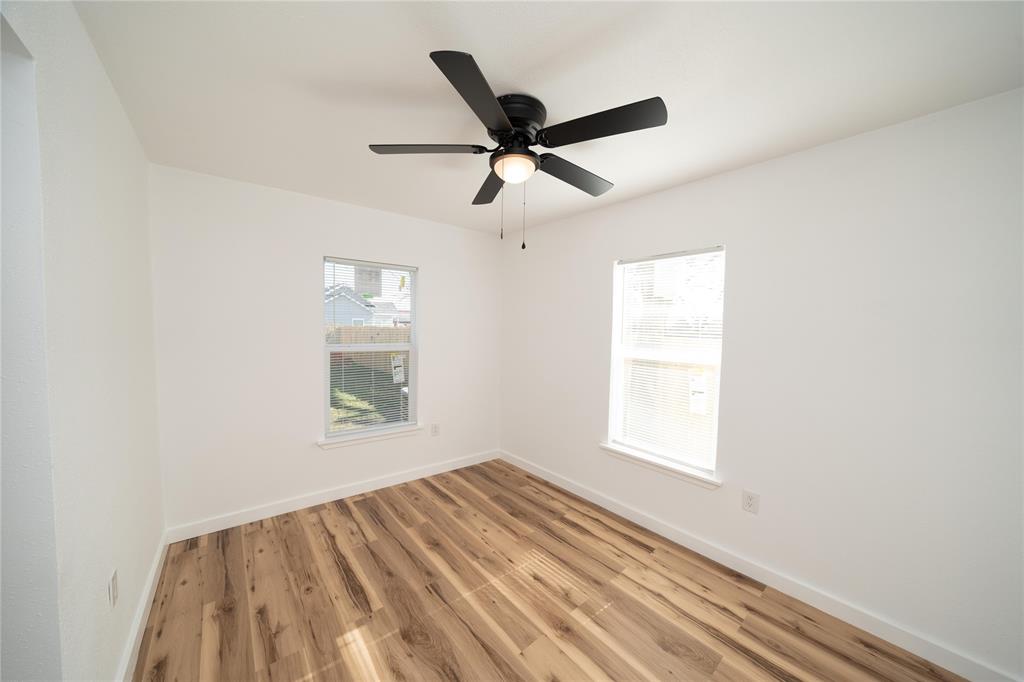 312 North Retta Street Fort Worth, TX 76111 - Photo 24 of 30 a view of empty room with wooden floor and fan