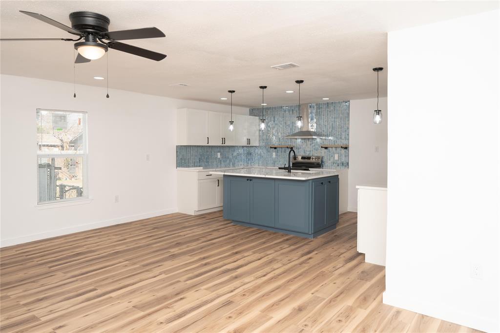 312 North Retta Street Fort Worth, TX 76111 - Photo 7 of 30 a view of a kitchen with kitchen island a sink stainless steel appliances and cabinets