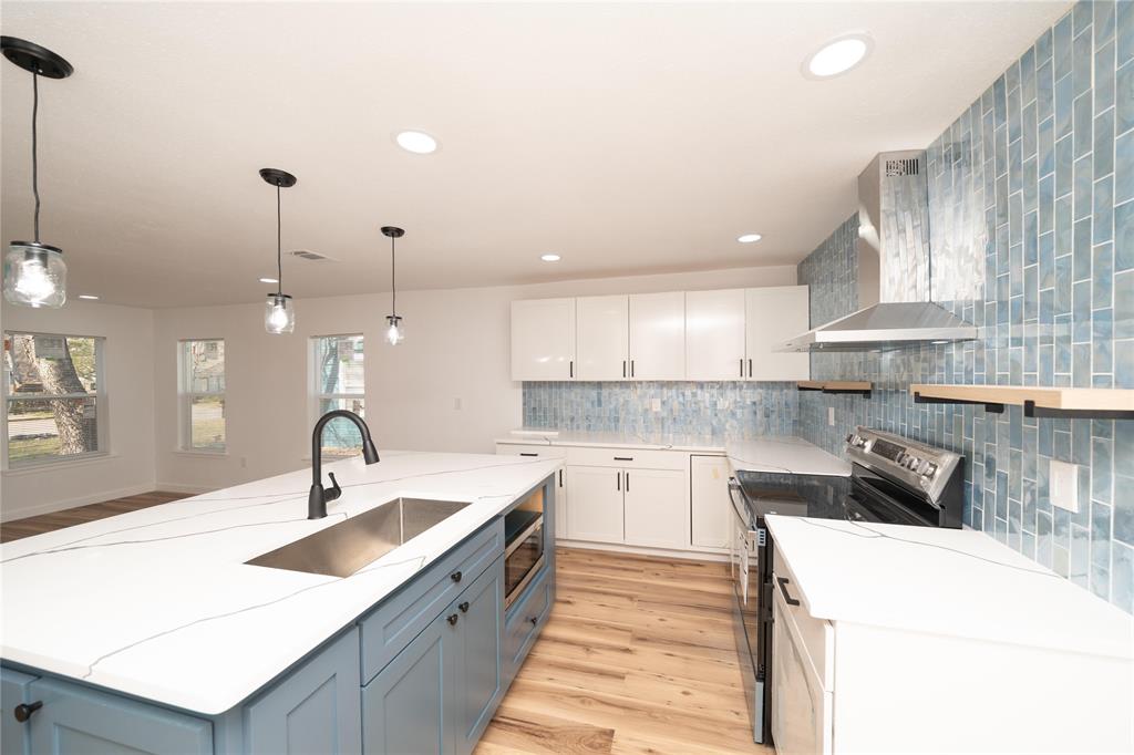 312 North Retta Street Fort Worth, TX 76111 - Photo 9 of 30 a kitchen with a sink a stove and cabinets