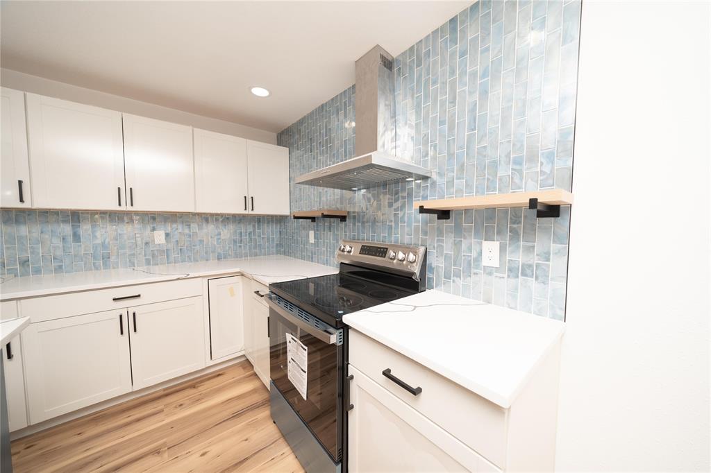312 North Retta Street Fort Worth, TX 76111 - Photo 10 of 30 a kitchen with a sink a stove and cabinets
