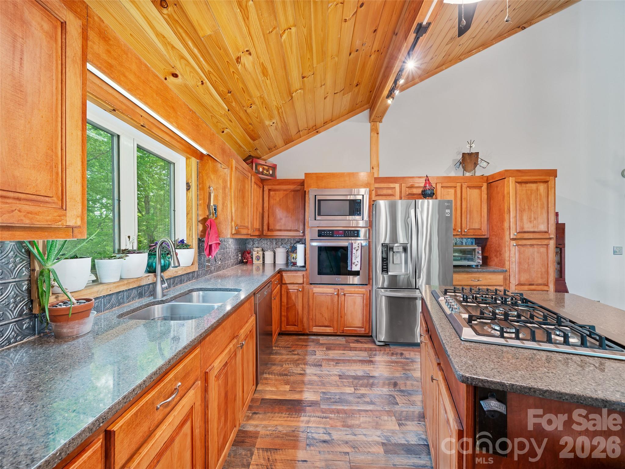 228 Continental Divide Road Spruce Pine, NC 28777 - Photo 10 of 48 a kitchen with stainless steel appliances granite countertop a sink stove and refrigerator