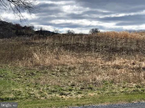a view of a backyard with white fence