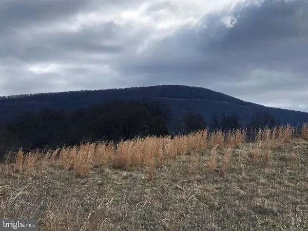 a view of a building with sitting area and furniture