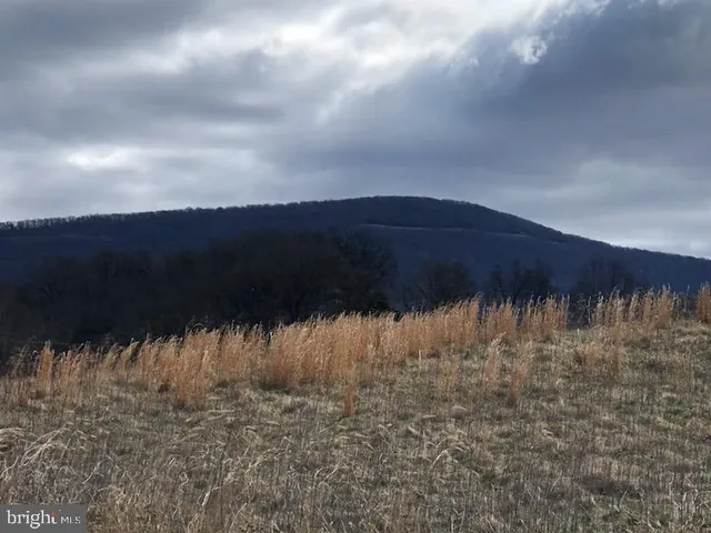 a view of a building with sitting area and furniture