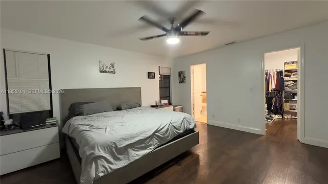 a bed room with a bed and a ceiling fan