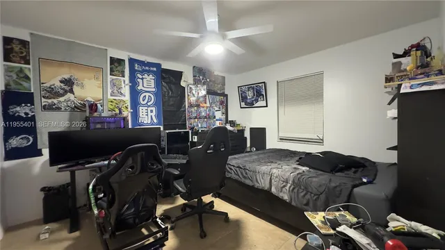 a bedroom with furniture and a flat screen tv