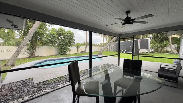a view of a patio with a table chairs and a backyard