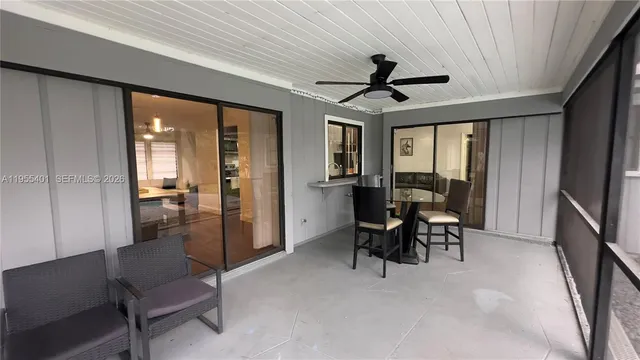 a view of a livingroom with furniture and a ceiling fan