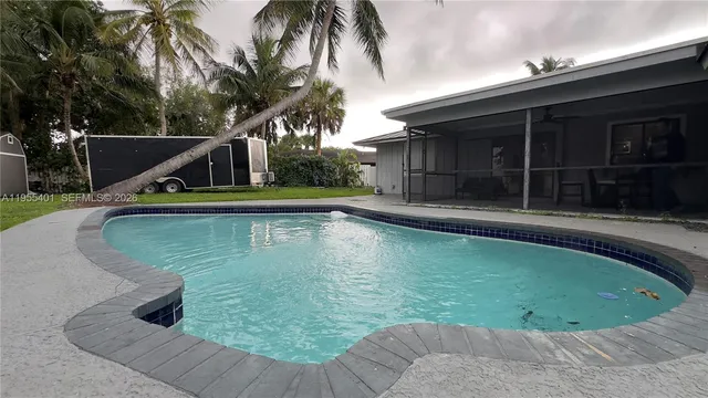 a view of a swimming pool with a patio