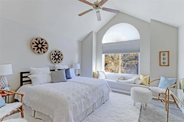 a bedroom with a bed and a large window