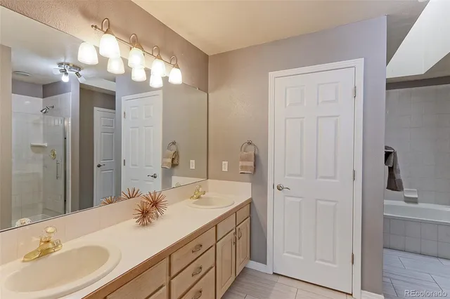 a bathroom with a double vanity sink and a mirror