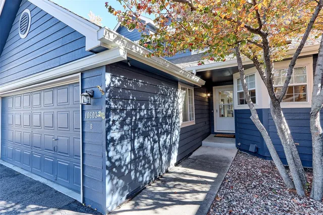 a front view of a house with wooden fence