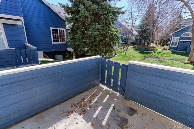 a wooden bench sitting in front of a building