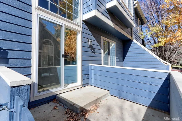 a view of house with wooden floor and a small yard