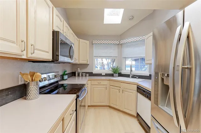 a kitchen with a sink stove and refrigerator