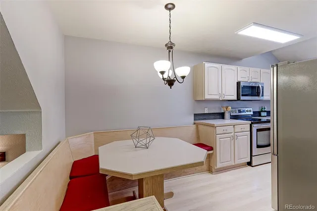 a kitchen with stainless steel appliances a sink a microwave a refrigerator and a stove